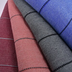 May include: Five fabric swatches in different colors, including pink, light blue, burgundy, coral, and gray. Each swatch has a subtle striped pattern and a black border.