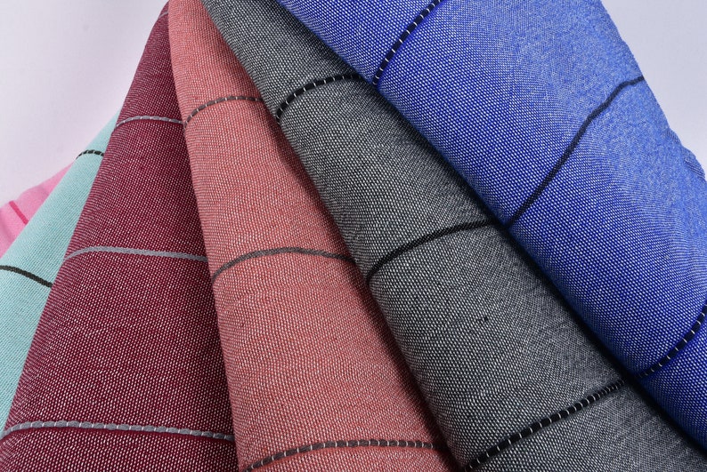 May include: Five fabric swatches in different colors, including pink, light blue, burgundy, coral, and gray. Each swatch has a subtle striped pattern and a black border.