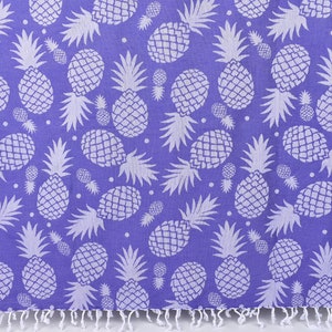 May include: A purple beach towel with a white pineapple pattern.