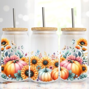 May include: Three white tumblers with a fall floral design featuring sunflowers, pumpkins, and leaves. Each tumbler has a wooden lid and a stainless steel straw.