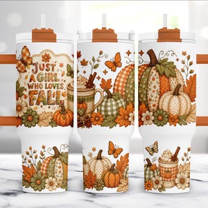 May include: A white tumbler with an orange handle and lid featuring a fall-themed pattern of pumpkins, autumn leaves, butterflies, and a mug of hot beverage. The text "JUST A GIRL WHO LOVES FALL" is printed in brown on the front of the tumbler.