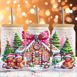 May include: Three white tumblers with lids and straws, decorated with a gingerbread house, Christmas trees, and gingerbread people. The tumblers are decorated with pink and white frosting, red candy canes, and green and white trees.