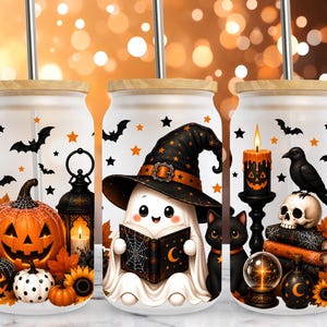 May include: Three frosted glass tumblers with bamboo lids and metal straws, featuring Halloween graphics including jack-o'-lanterns, a ghost wearing a witch hat reading a book, a black cat, a raven, a skull, candles, and autumn leaves.