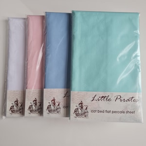 May include: Four cot bed flat percale sheets in white, pink, light blue, and teal, each in a clear plastic package. The sheets have the "Little Pirates" logo with a ship illustration. The text "cot bed flat percale sheet" is also visible.
