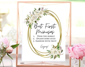 May include: A printable sign with a gold floral wreath and the text "But First, Mimosas" with instructions for making mimosas: 1. Pour the bubbly, 2. Splash some juice, 3. Garnish with fruit. The sign also says "Enjoy!"