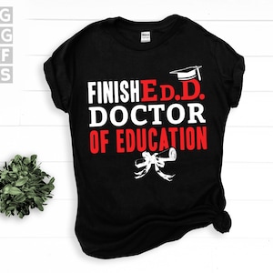May include: Black t-shirt with white text that reads "Finished E.D.D. Doctor of Education" with a graduation cap and scroll graphic.