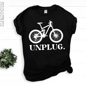 May include: Black t-shirt with a white silhouette of a mountain bike and the text "UNPLUG."