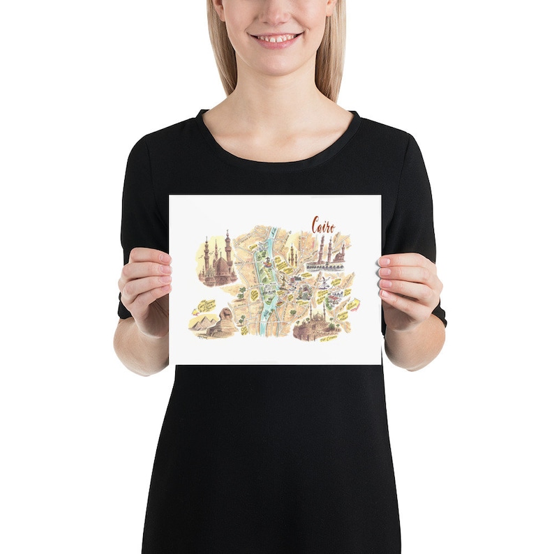 May include: A colorful illustrated map of Cairo, Egypt, with the Nile River running through the center. The map features landmarks like the Great Mosque of Muhammad Ali, the Citadel of Cairo, and the Sphinx.