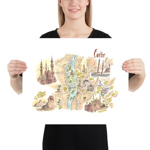 May include: A colorful illustrated map of Cairo, Egypt, with landmarks like the Great Pyramids, the Sphinx, and the Citadel of Cairo. The map is drawn in a whimsical style with a light brown background and blue river.