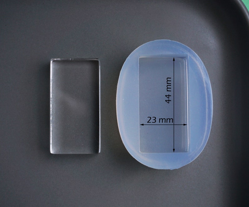 Peut inclure: Un moule en silicone rectangulaire transparent pour la coul&eacute;e de r&eacute;sine. Le moule mesure 23 mm de large et 44 mm de haut.