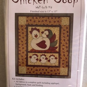 May include: A wall quilt kit featuring a chicken coop design with a mother hen and chicks. The kit includes all fabrics, patterns, and instructions to complete the quilt. The finished size is 33 cm by 38 cm. Item # K0607