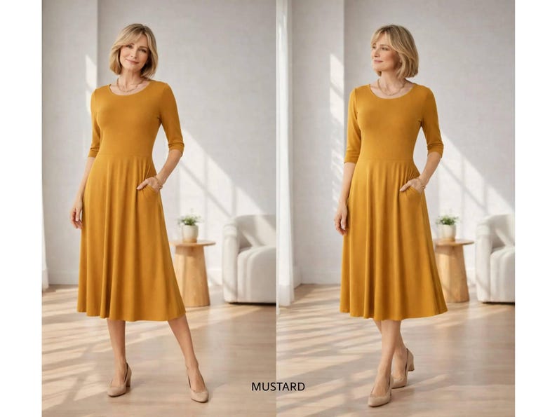 Op de afbeelding: Mosterdkleurige midi-jurk met een ronde hals en driekwart mouwen. De jurk heeft zakken en een uitlopende rok. Het woord "MUSTARD" staat onderaan de afbeelding.