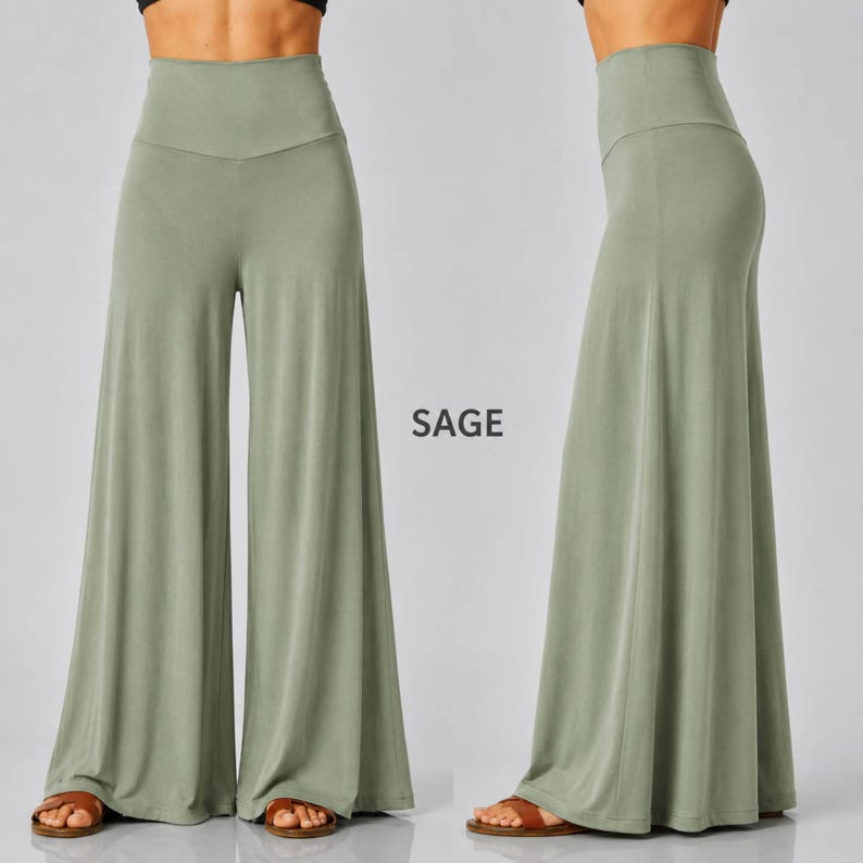 Puede incluir: Pantalones de pernera ancha y cintura alta en color verde salvia, mostrados de frente y de lado. Los pantalones presentan un color s&oacute;lido, una textura de tela suave y una silueta ancha y fluida que llega hasta el suelo. El texto SAGE est&aacute; impreso en el centro.