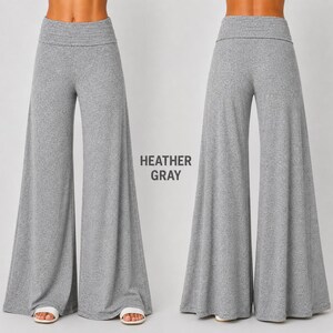 Puede incluir: Pantalones de pierna ancha en color gris jaspeado con cintura alta plegable. Los pantalones se muestran desde la vista frontal y trasera, exhibiendo una silueta holgada y fluida que llega hasta el suelo. El texto HEATHER GRAY es visible.