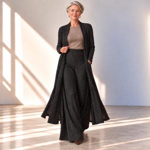 May include: A long-sleeved, open-front charcoal gray duster cardigan worn over a matching pair of high-waisted, wide-leg trousers and a solid light brown crew-neck top. The cardigan and trousers feature a subtle, fine vertical ribbed texture.