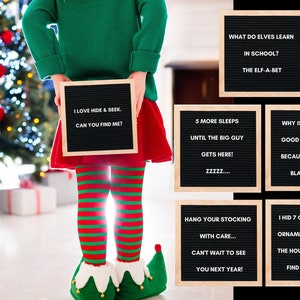 May include: A person dressed as an elf holds a letter board that says "I LOVE HIDE & SEEK. CAN YOU FIND ME?" Other letter boards display Christmas jokes and messages. The person is wearing a green top, red skirt, striped tights, and elf shoes.