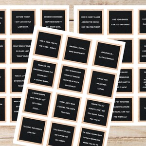 May include: A collection of letter board signs with various holiday-themed puns and jokes. Each sign features black felt with white lettering, framed by a light brown border. The signs are arranged on a white background.