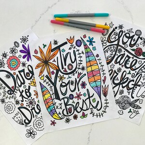 May include: Three printable coloring pages with inspirational messages. The first page says "Dare to Dream", the second page says "Try Your Best", and the third page says "You Are Perfect". Each page features a colorful floral design.