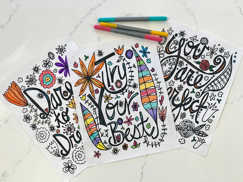 May include: Three printable coloring pages with inspirational messages. The first page says "Dare to Dream", the second page says "Try Your Best", and the third page says "You Are Perfect". Each page features a colorful floral design.
