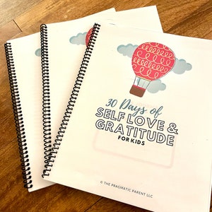 May include: Three spiral bound journals with a white cover and a hot air balloon graphic. The cover reads "30 Days of Self Love & Gratitude for Kids" and is copyrighted by The Pragmatic Parent LLC.