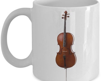 May include: White ceramic coffee mug with a brown cello printed on the front.