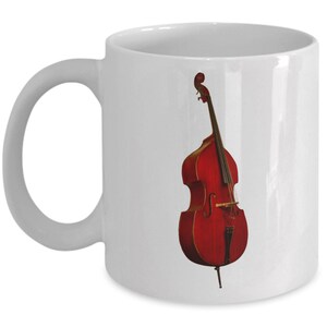 May include: White ceramic coffee mug with a red double bass printed on the side.