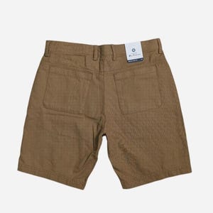 May include: Brown shorts with two back pockets and a textured pattern. The shorts have a tag that reads "Ben Sherman" and "Regular Fit".