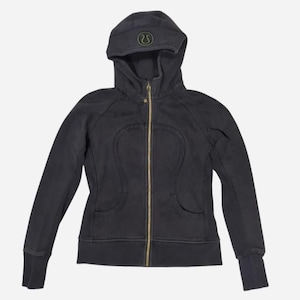 May include: A dark gray hooded sweatshirt with a full-length gold zipper. The sweatshirt features a hood with a small logo and two front pockets. The cuffs and waistband are ribbed. The logo is a stylized omega symbol.