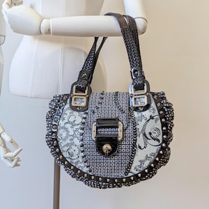 Authentic Vintage Y2K Versace black and white patchwork leather shoulder bag with silver hardware from their Spring Summer 2010 Ready to Wea