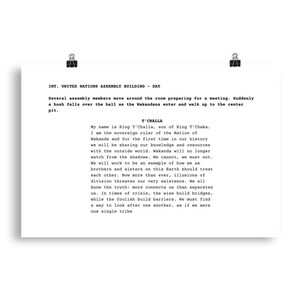 May include: A white poster with black text, held by two binder clips. The text describes a scene at the United Nations Assembly Building, featuring King T'Challa of Wakanda. The text is a speech about sharing knowledge and resources.