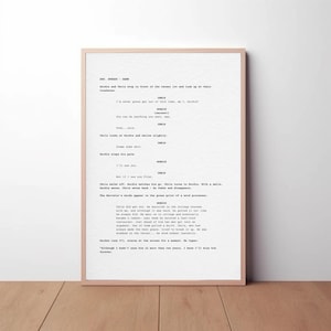 May include: A framed movie script print. The text is black on a cream background, set within a light-coloured wooden frame. The script includes character names and dialogue. The overall aesthetic is classic and minimalist, suitable for home decor.