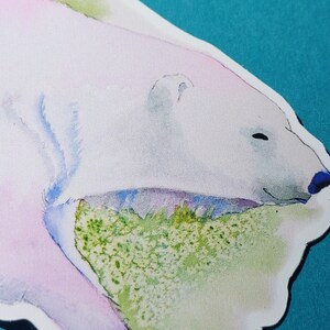 May include: A watercolor painting of a polar bear with a pink and blue hue, resting its head on a green and white background.