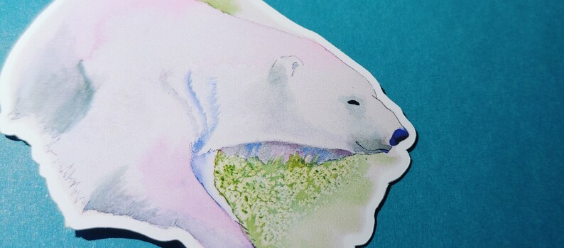 May include: A watercolor painting of a polar bear with a pink and blue hue, resting its head on a green and white background.