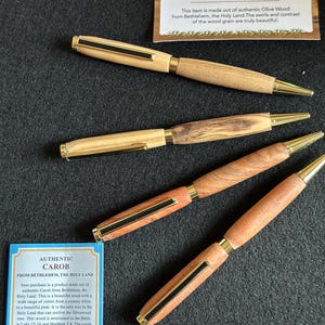 Hand made ball point pen from Carob or Olivewood certified from Bethlehem. The lighter color is Olive Wood, the darker is Carob