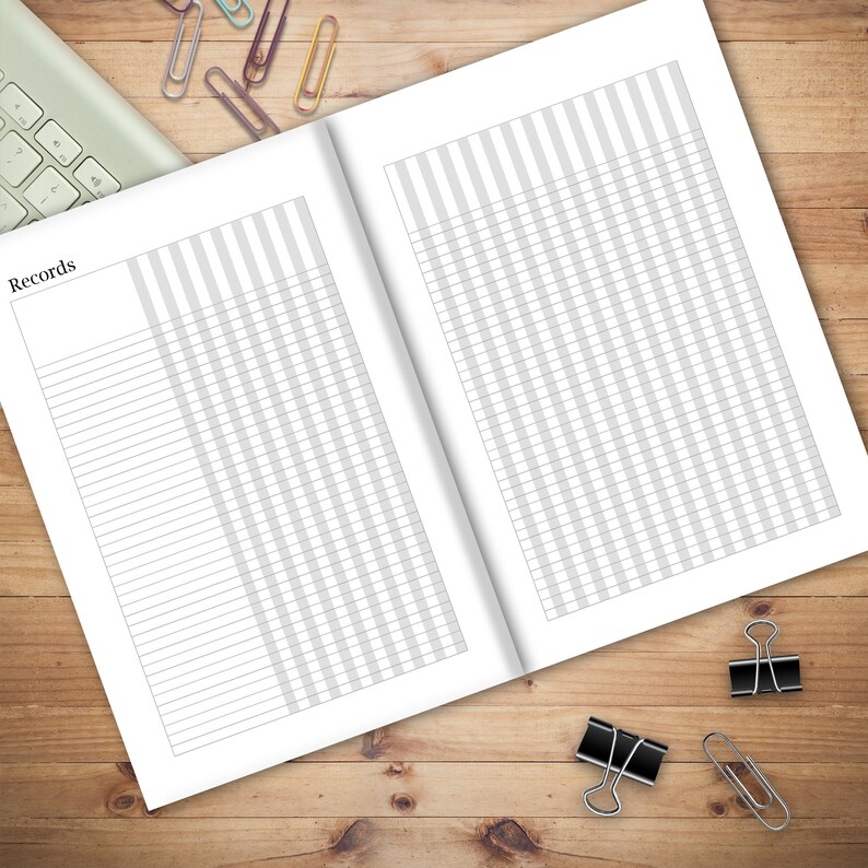 May include: A blank, white, lined notebook with a gray striped pattern on the cover. The notebook is open to two blank pages. The word "Records" is printed at the top of the left page.