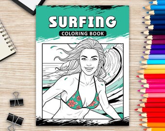 May include: A "Surfing Coloring Book" with a teal and white cover. The cover features a black and white illustration of a woman surfing, wearing a floral bikini. The title is in large white letters with a teal background. Colored pencils are arranged along the right side.
