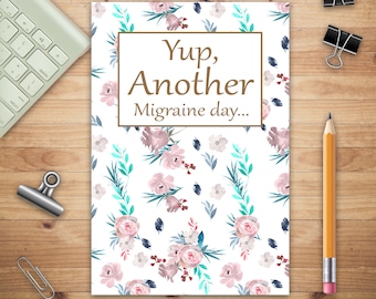 May include: A white card with a floral pattern and the text "Yup, Another Migraine day..." in brown text.