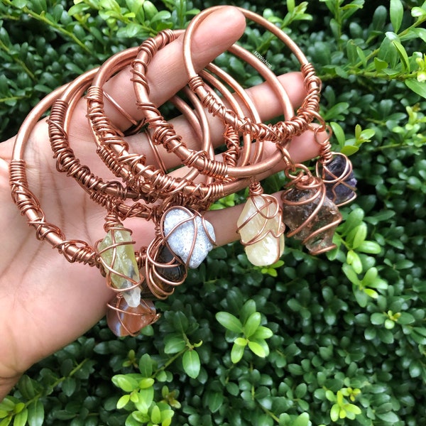 Copper bangles with a dangling crystal