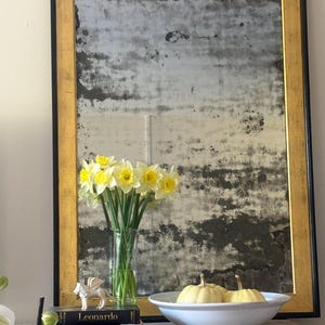 Antique French Foxed glass mirror in a gilt and black colour frame. Large proportions. Superb