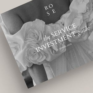 May include: Monochrome image of a guide titled "the SERVICE INVESTMENT guide" with the word "ROSE" at the top. The guide is held by a person wearing a dress with floral embellishments. The text "SPRING 2026" is also visible.