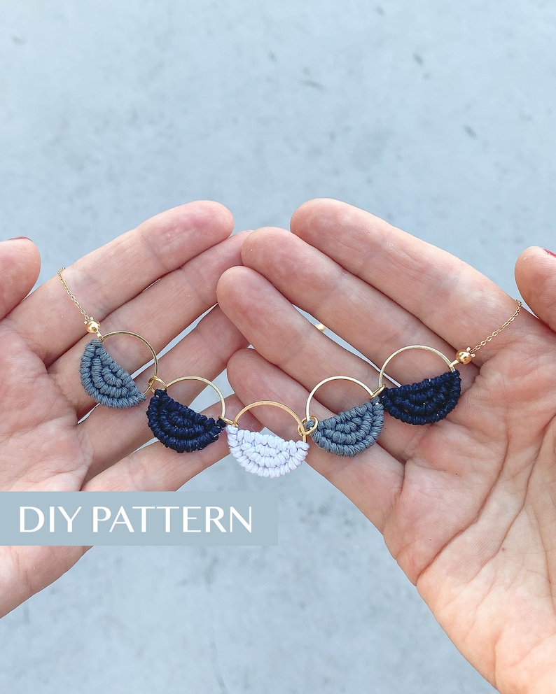 May include: A gold chain necklace with four small, half-circle macrame charms in grey, white, and black. The text "DIY PATTERN" is visible at the bottom of the image.