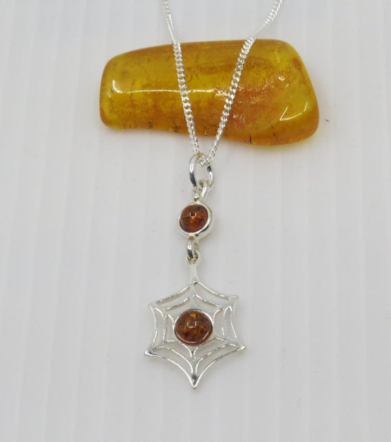 Handmade Baltic Amber cobweb design pendant set in sterling silver