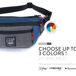 May include: Blue and gray fanny pack with a black strap and red zipper pulls. The pack has a checkered pattern on the front pocket and the text "GUNUNG API". The text "CHOOSE UP TO 3 COLORS!" is also visible.