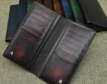 May include: A burgundy leather wallet with multiple card slots and a large bill compartment. The wallet is open to show the interior and has the letters A and B marked on the outside.