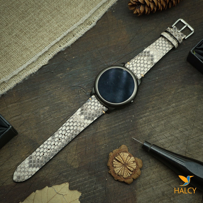 The python leather watch strap fitted on a stylish watch, demonstrating its sleek and luxurious look when worn.
