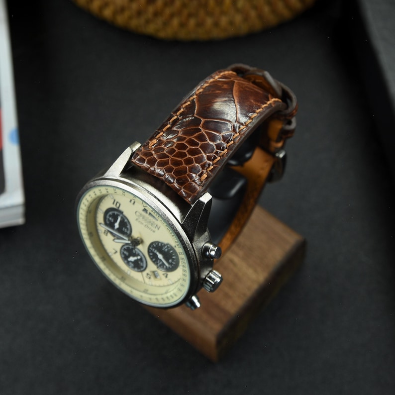 A close-up of the brown ostrich leg leather watch strap with a glossy finish, highlighting the luxurious texture and soft, supple leather, perfectly complemented when attached to the watch.