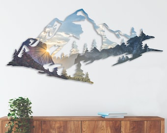 May include: A white silhouette of a mountain range with a sunset scene inside. The silhouette is mounted on a white wall above a wooden cabinet.