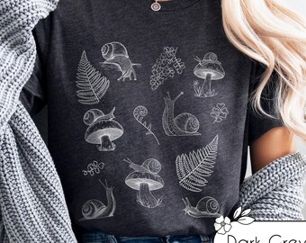 Snail shirt minimalist goblincore clothing. Snails, mushrooms, and ferns t-shirt for forest, naturecore, and cottagecore lovers.