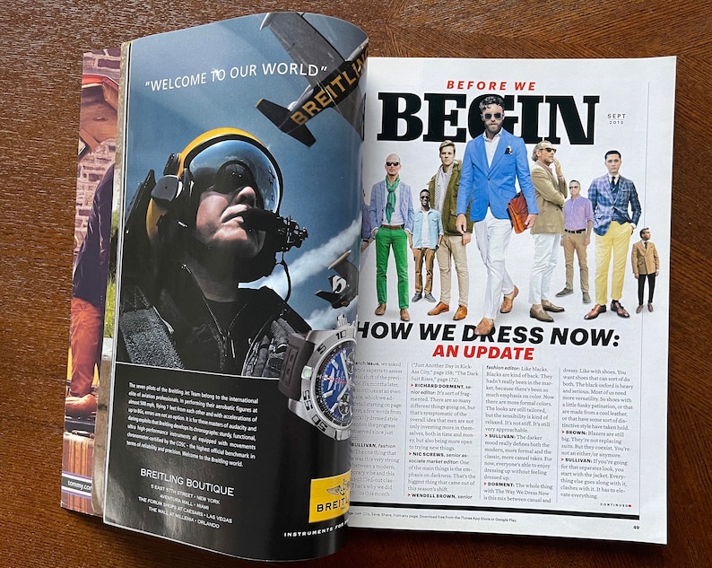 May include: A magazine spread featuring a group of men in various styles of clothing, with the headline "How We Dress Now: An Update". The text discusses current fashion trends and includes a quote from "The Way We Dress Now" by Wendell Brown.