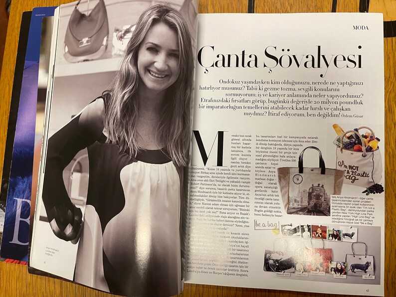 May include: A magazine spread featuring a black and white photo of a woman with long hair, wearing a black and white top. The magazine article is about handbags and features the text "&Ccedil;anta Ş&ouml;valyesi" and "I'm not a plastic bag".